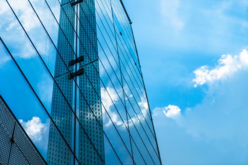 building with glasses and bright sky