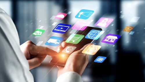 Hands simulating holding a tablet with apps floating