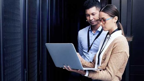 two people looking at a laptop
