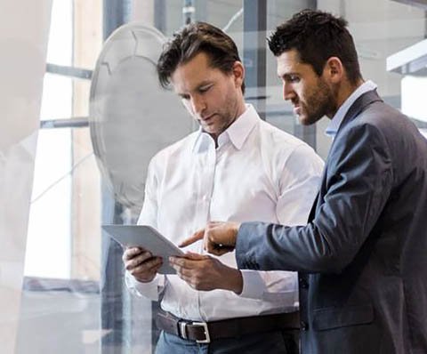 two people looking at a tablet