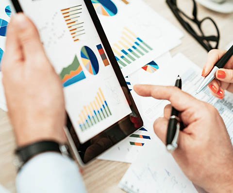 person looking at graphs on a tablet