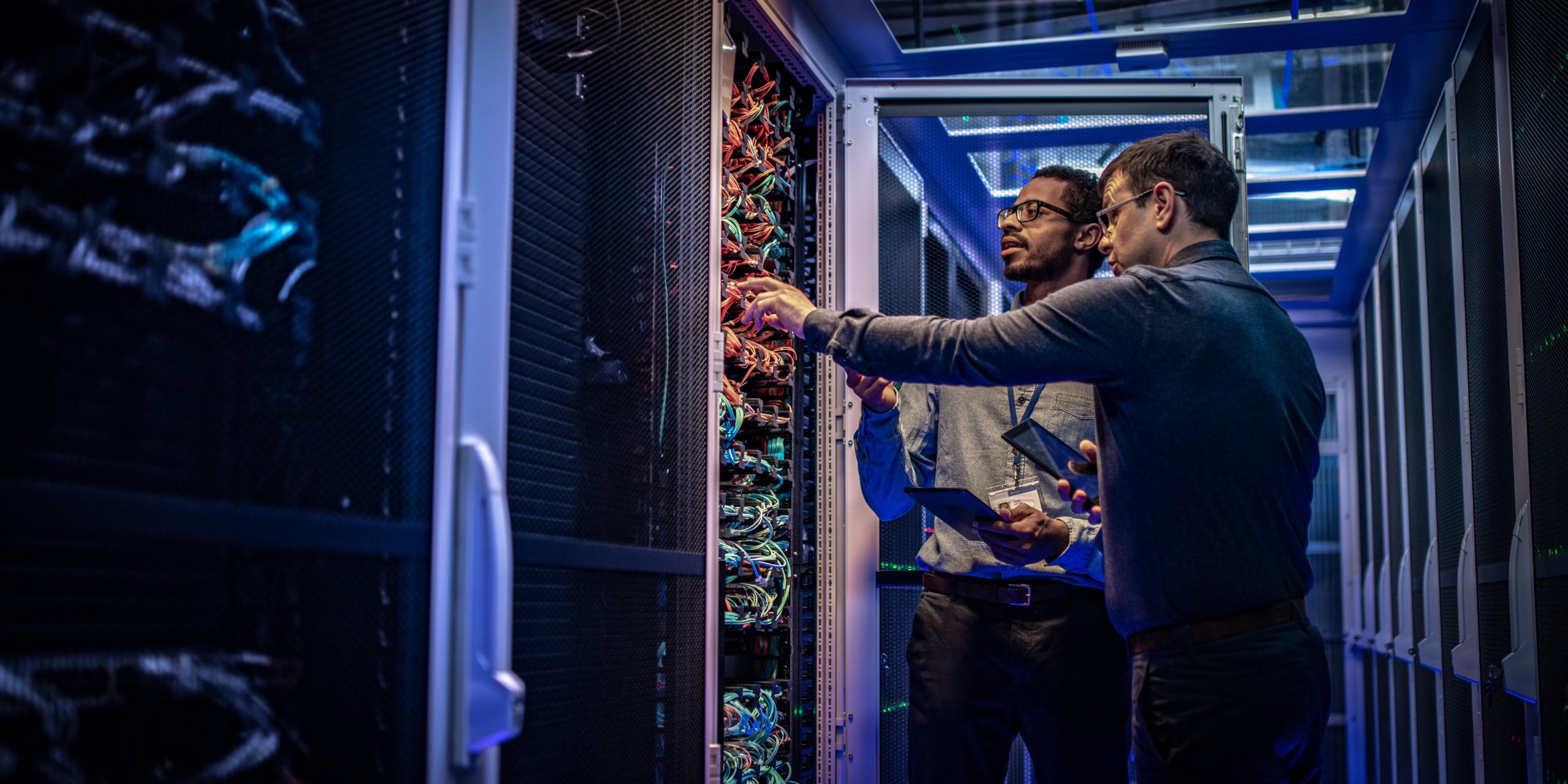 two people in a data center