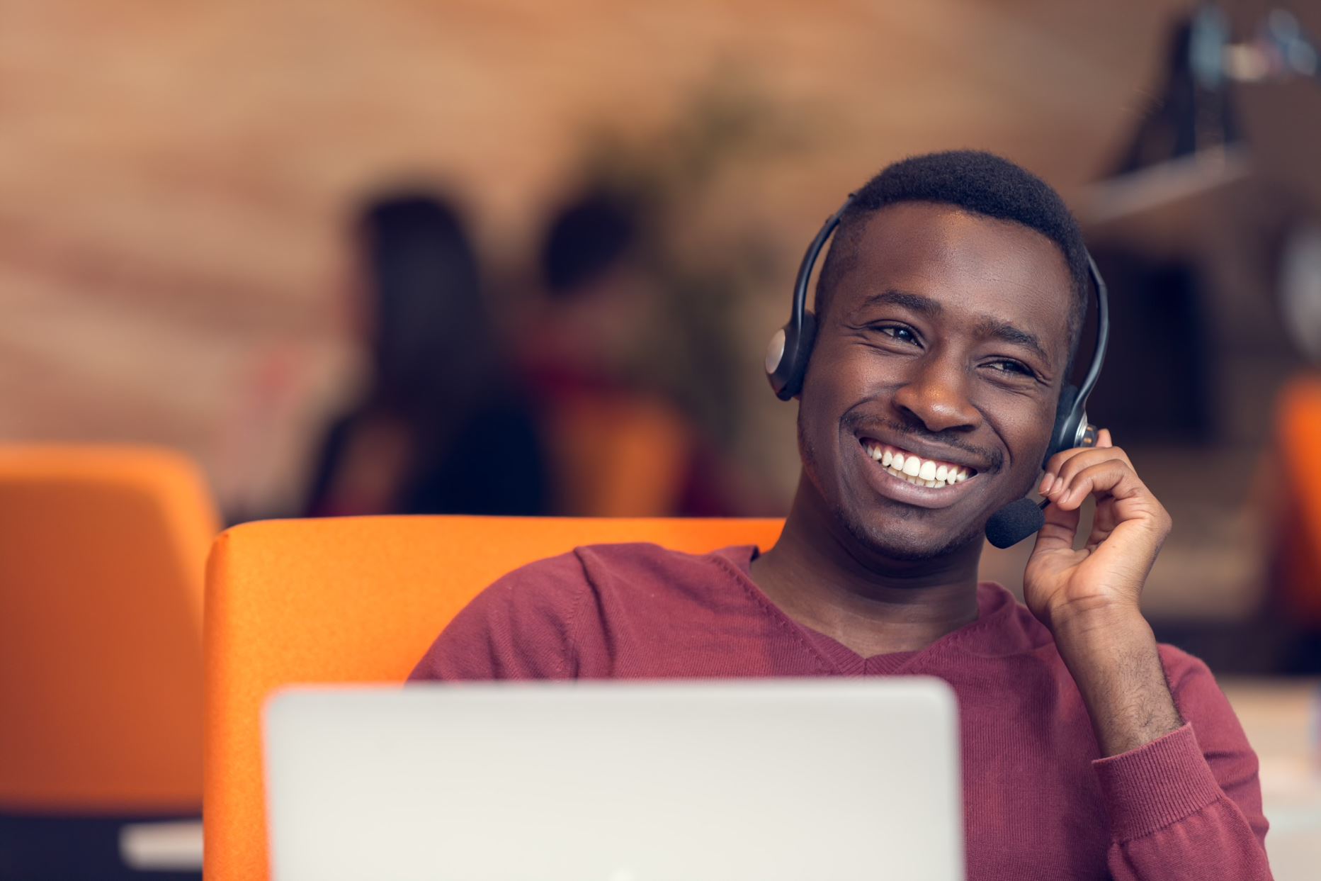 person with headphones working on the computer
