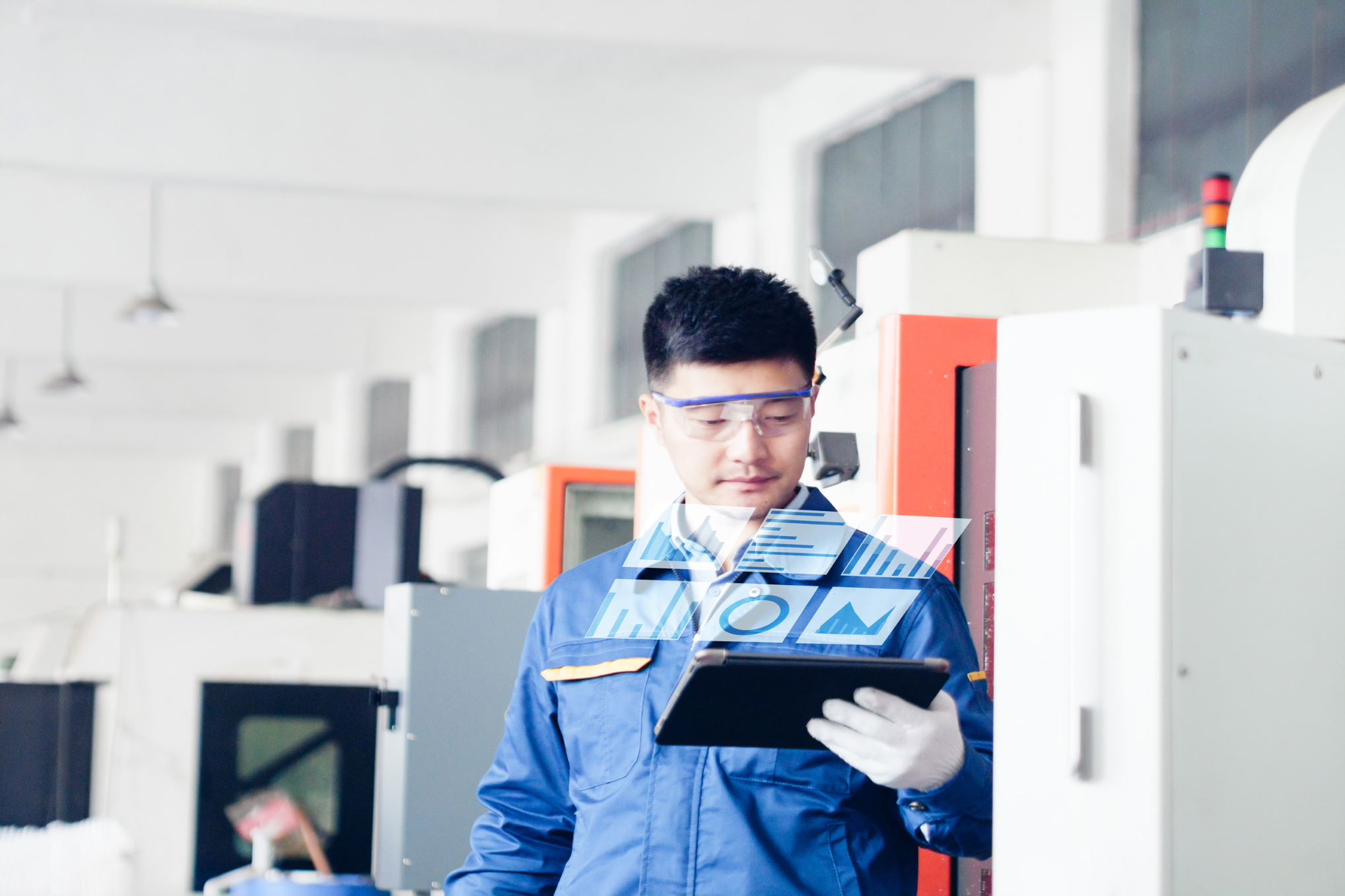 engineer looking at tablet with graphs on it