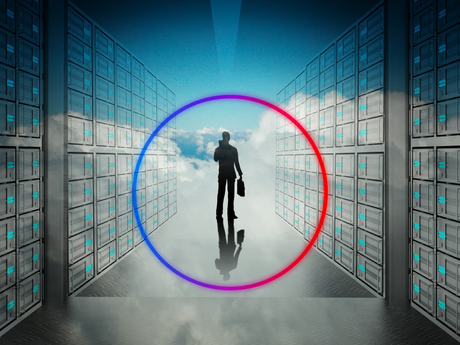 A silhouette of a professional walking through a row of data center servers heading towards a skyline of clouds