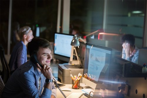 people working in the office at night
