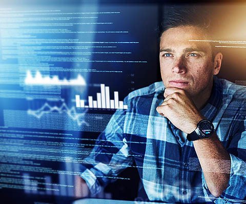 man looking at a screen with graphs on it