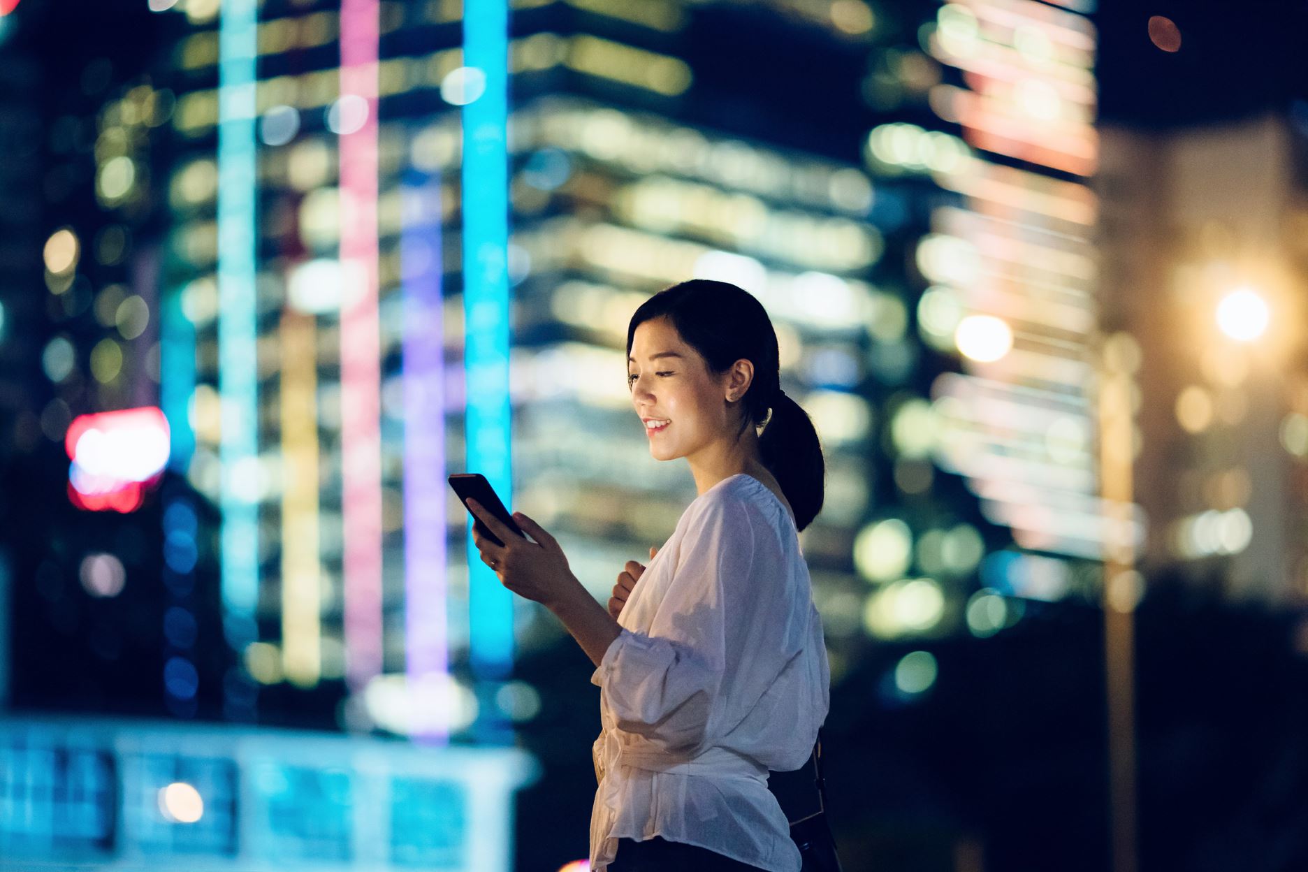 person looking at the phone and smiling