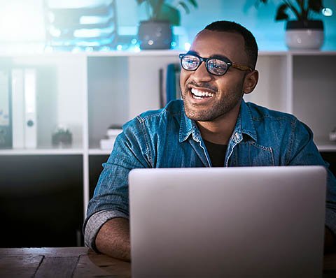 guy on his laptop laughing