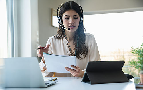 woman with headphones and a microphone working