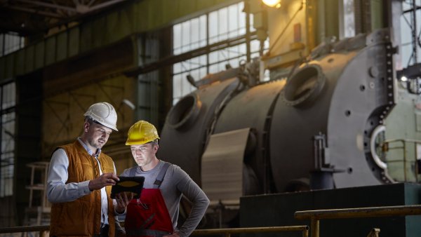 two engineers in front of a machine