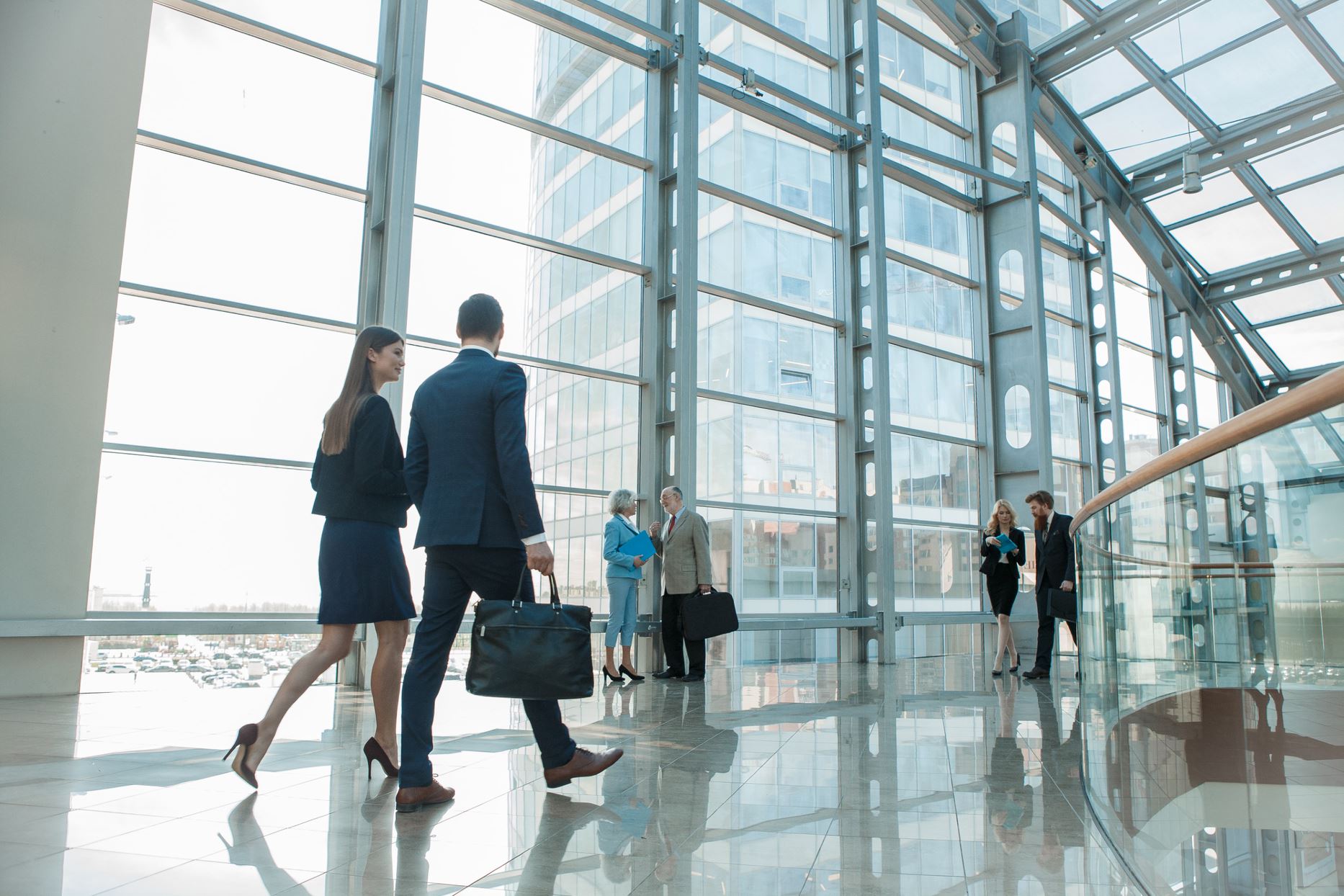 people walking in a building of glasses