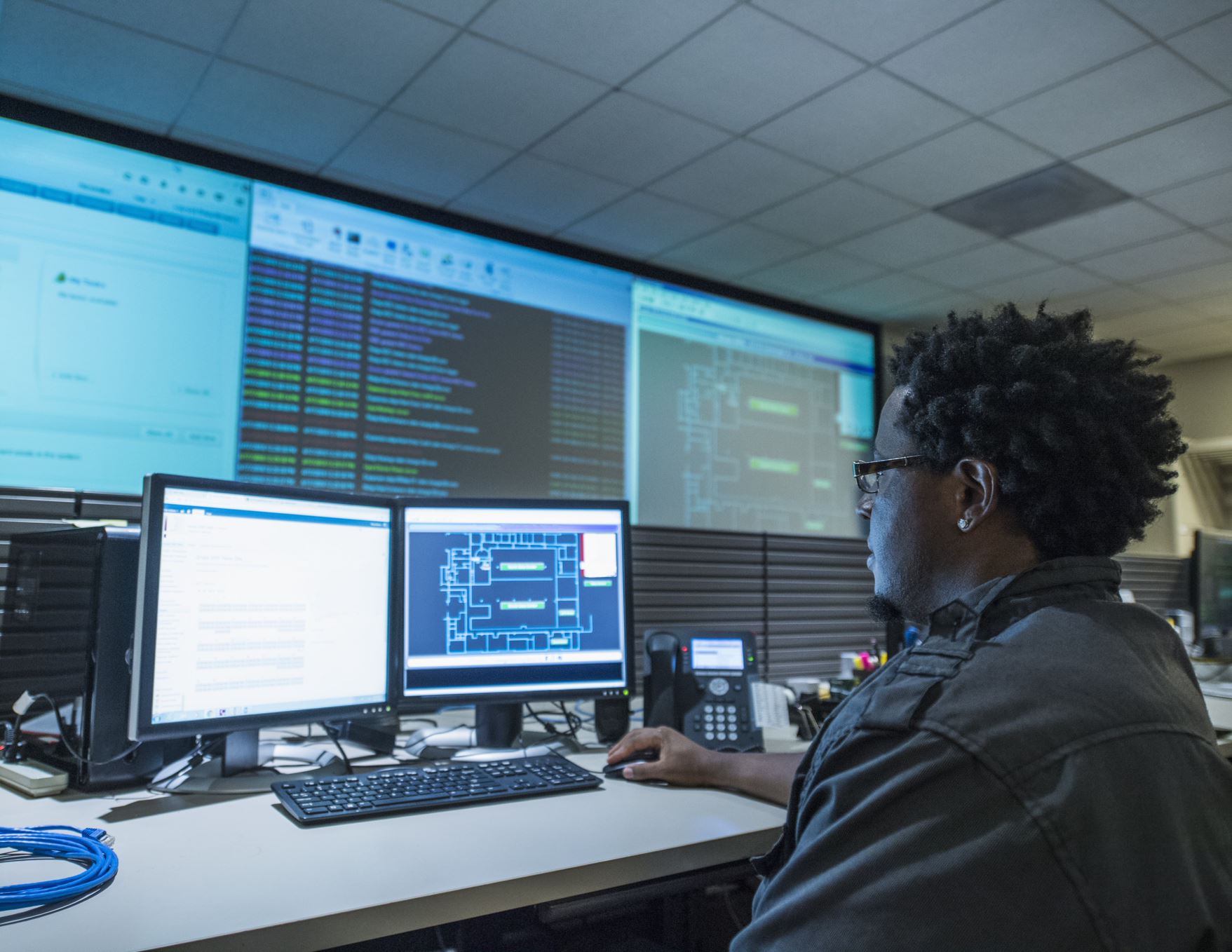 person working on multiple screens