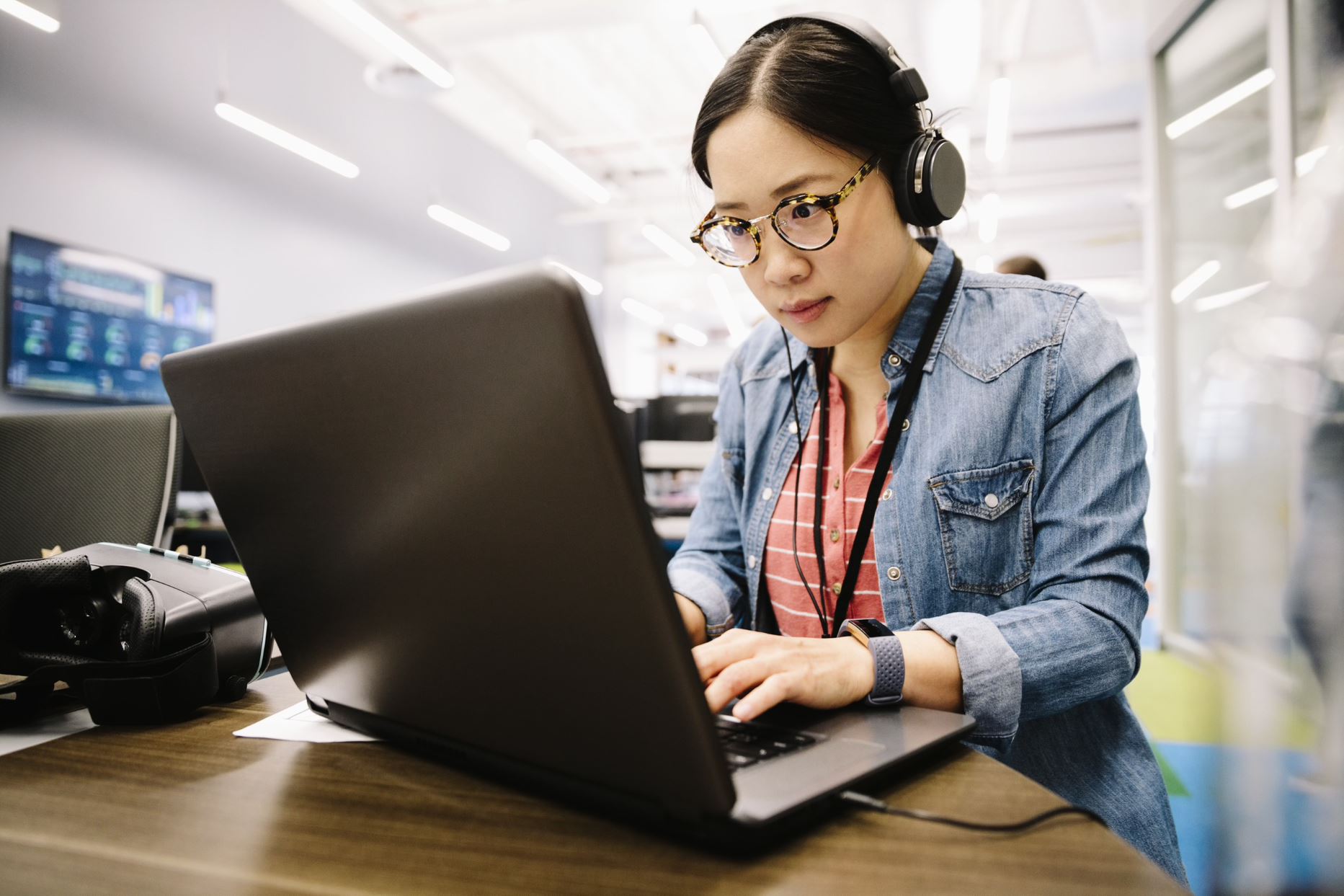 person with headphones working on the computer