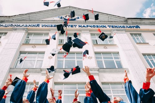 graduates throwing their hats