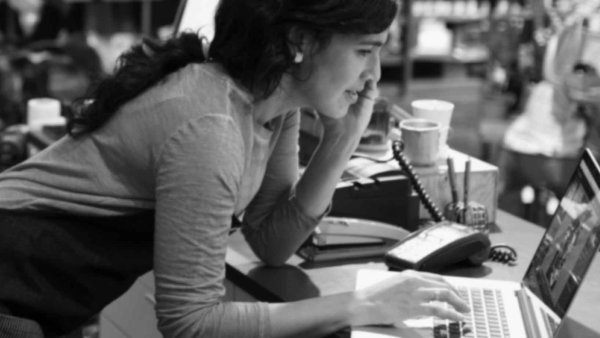 Woman standing up while seeing something on her computer