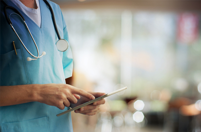 healthcare professional using tablet device