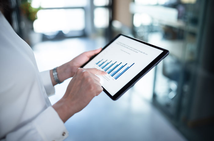 woman pointing at data on a tablet