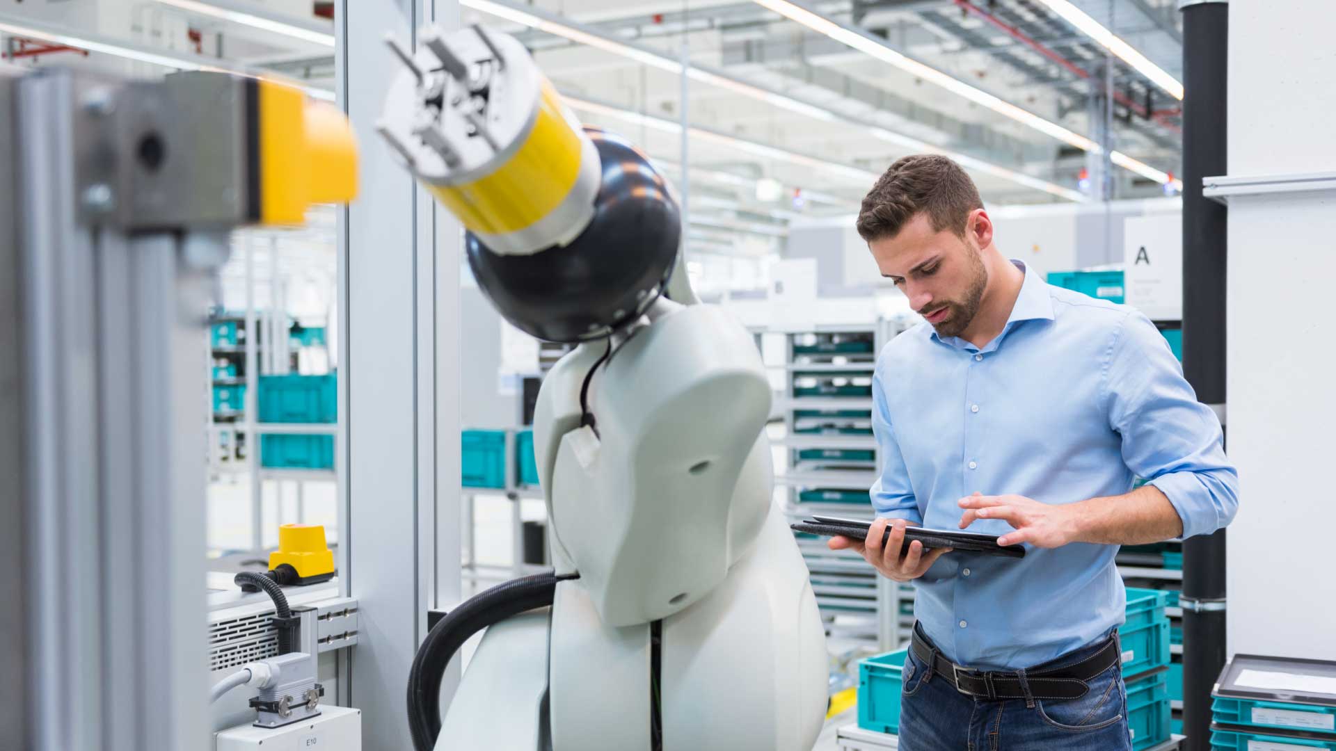 robot arm with a guy on an ipad