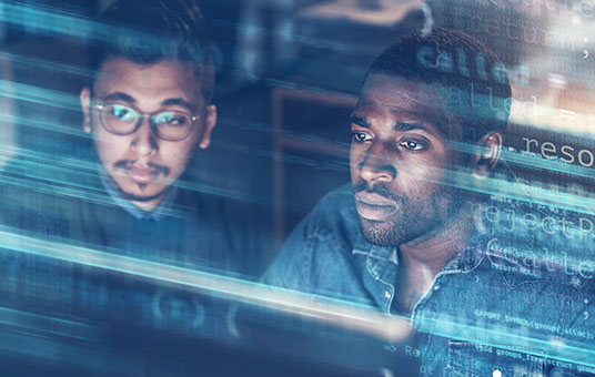 two men looking at a screen