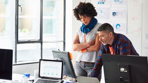Man and woman looking at a computer screen